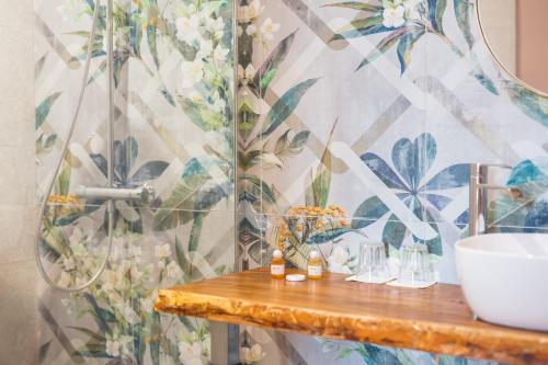 a bathroom with a sink and a wall mural at Chambres d'hôtes - Domaine de Cristia in Courthézon