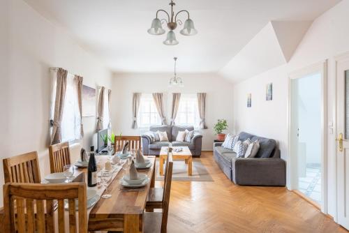 a dining room and living room with a table and chairs at St. George Apartments in Prague