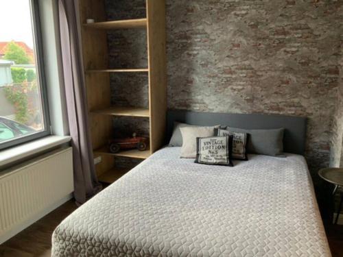 a bedroom with a bed with pillows on it at Wohnung Midcoast im Herzen von Schleswig-Holstein in Nortorf