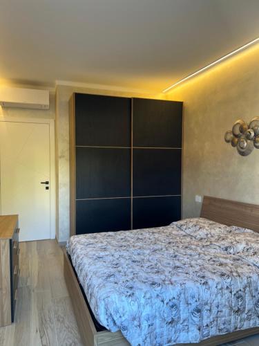 a bedroom with a large bed with a large headboard at Corso montecarlo in Ventimiglia