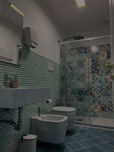 a bathroom with a sink and a toilet and a shower at Palazzo Della Guardia in Vietri sul Mare