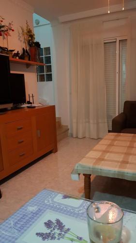 a living room with a table and a tv at Casa Horadada in Algorfa