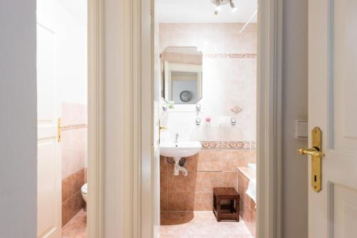 a bathroom with a sink and a mirror at St. George Apartments in Prague