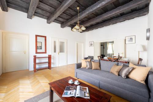 a living room with a couch and a table at St. George Apartments in Prague