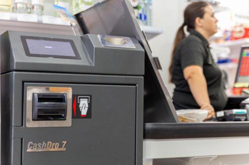 a woman working at a cash register in a store at Complejo Turístico Los Escullos Cabo de Gata in Los Escullos