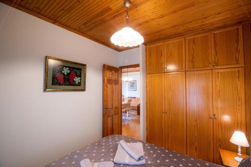 a bedroom with a bed and a wooden cabinet at Chrysanthe [ Portaria ] Traditional Pelion House in Portariá