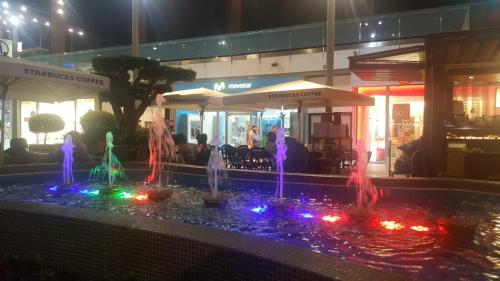 a fountain with colorful lights in front of a building at Casa Horadada in Algorfa