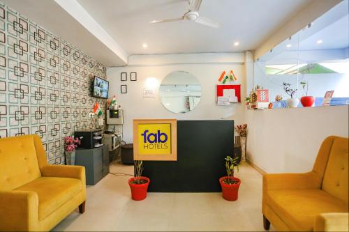 a lobby of a hotel with two chairs and a table at FabHotel Novel Suites in New Delhi