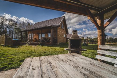 a wooden deck in front of a log cabin at Kaszuby wczasy u Danusi sauna i bania in Lipusz