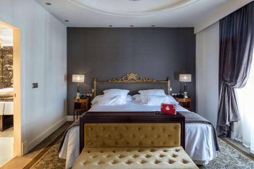 a bedroom with a bed with a red box on it at Wellington Hotel & Spa Madrid in Madrid