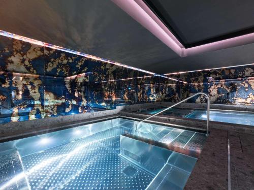a large swimming pool in a room with a wall at Wellington Hotel & Spa Madrid in Madrid