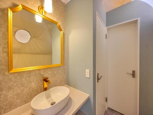 a bathroom with a white sink and a mirror at Mt,Fuji Glamping Terrace Minenohana - Vacation STAY 35711v in Oishi