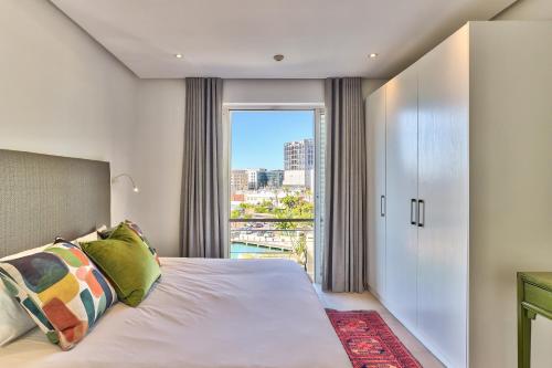 a bedroom with a bed and a large window at Luxury three Bedroom Apartment - fully furnished and equipped in Cape Town