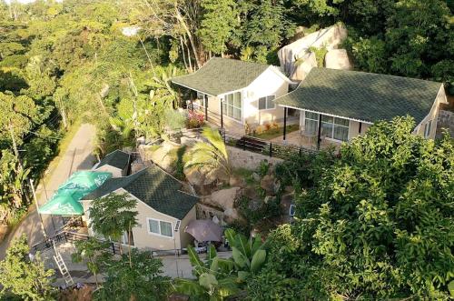 an aerial view of a house in the forest at Takamakasky Villas in Takamaka