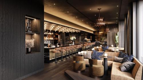 a restaurant with couches and a bar with a counter at Hotel AMANO Covent Garden in London