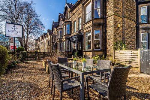 a table and chairs in front of a building at Fountains Guest House - Harrogate Stays in Harrogate