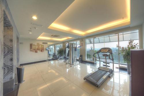 a gym with a treadmill in the middle of a room at Arenaa Deluxe Hotel in Melaka