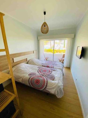 a bedroom with a bed and a ladder at Cabedelo Beach Loft in Darque