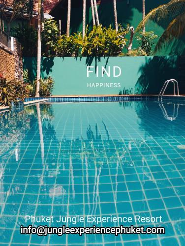 a swimming pool at the find happiness hotel in singapore at Phuket Jungle Experience Resort in Karon Beach