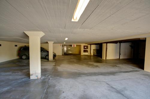 an empty parking garage with a car parked in it at Chesa Munteratsch 1-Zimmerwohnung 203 Typ B in Silvaplana