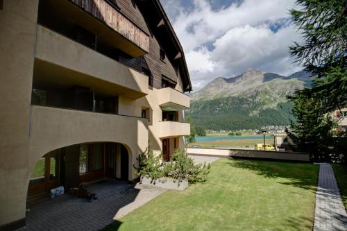 a building with a view of a mountain at Chesa Munteratsch 2-Zimmerwohnung 201 Typ E in Silvaplana