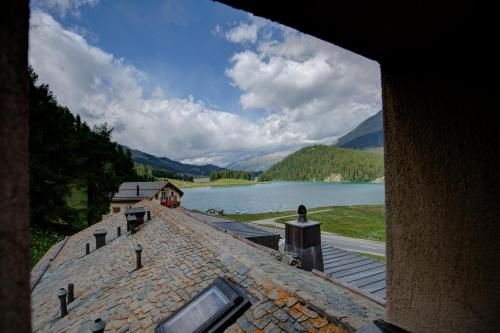 a view of a building with a view of a lake at Chesa Munteratsch 2-Zimmerwohnung 201 Typ E in Silvaplana