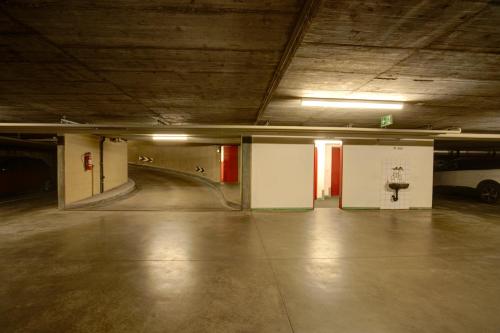 an empty parking garage with a car parked in it at Chesa Munteratsch 2-Zimmerwohnung 201 Typ E in Silvaplana