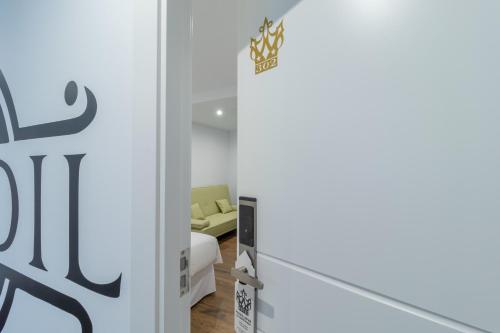 a door leading into a room with a bed at Hotel Reina Aixa in Cogollos de Guadix