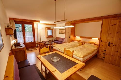a bedroom with a bed and a table in it at Chesa Munteratsch 1-Zimmerwohnung 307 Typ B in Silvaplana