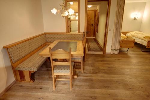 a dining room with a table and a mirror at Chesa Munteratsch 1 1 2-Zimmerwohnung 409 Typ C in Silvaplana