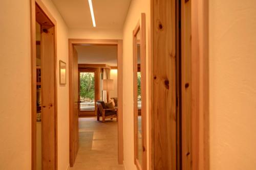 a hallway leading to a living room with a chair at Chesa Munteratsch 1 1 2-Zimmerwohnung 209 Typ D in Silvaplana