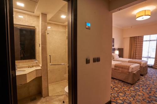 a hotel room with a bed and a bathroom at Al Hidayah Towers Hotel in Makkah