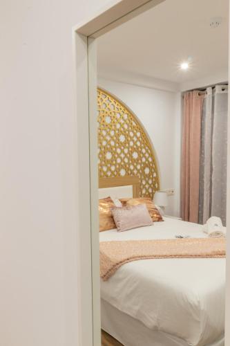 a bedroom with a bed with a large mirror at Hotel Reina Aixa in Cogollos de Guadix