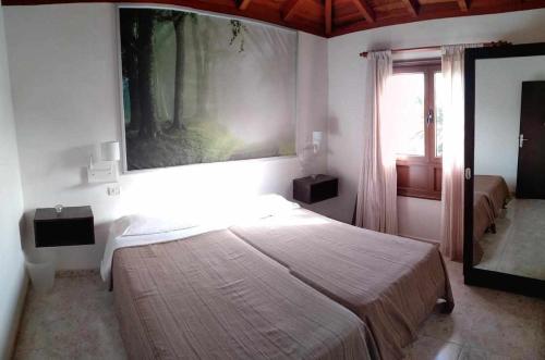 a bedroom with a large bed and a window at Chijere San Sebastián in San Sebastián de la Gomera