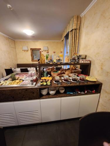 a buffet in a hotel room with food on it at Hotel Millennium in Locarno