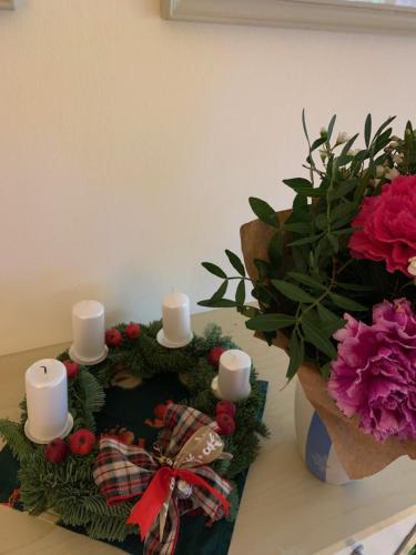 a christmas wreath with candles and flowers on a counter at Residence Sarka in Prague