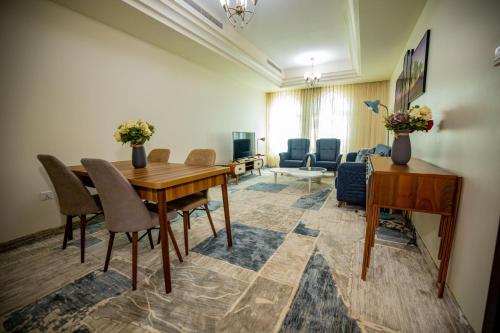 a living room with a wooden table and chairs at Niamey Mall & Residence in Niamey