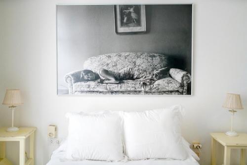 a black and white photo of a bed and a couch at Eva Recommends Gamazo in Seville