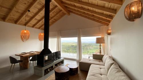 a living room with a couch and a fireplace at Casas Fonte da Tapada - Casa da Fonte in Trancoso