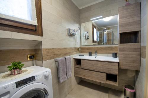 a bathroom with a washing machine and a sink at Home, sweet home in Livigno
