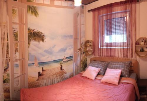 a bedroom with a beach mural on the wall at Apartman Palić Libero in Palić