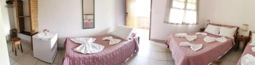 two pictures of a room with a bed and a couch at Pousada Namuncurá in Arraial d'Ajuda