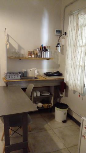 a kitchen with a counter and a table in a room at Loft Rufino in Mendoza