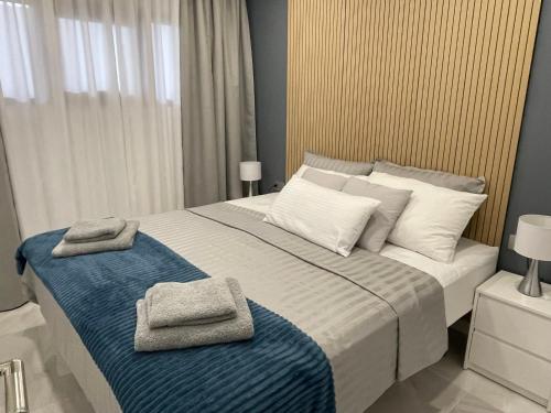 a bedroom with a large bed with towels on it at Luxury Diamond - Ocean view, Big terraces, Air Con, Wifi in Los Cristianos