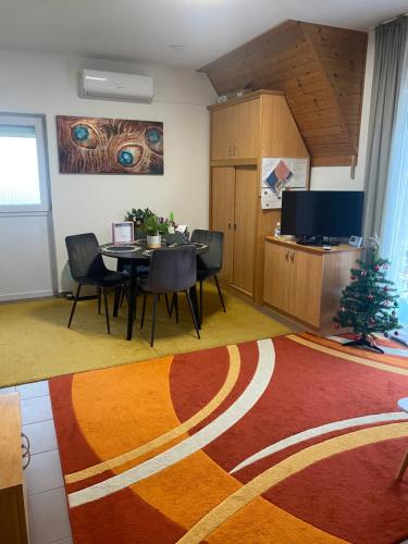 a dining room with a table and a christmas tree at Chestnut Hill- Zalakaros in Zalakaros