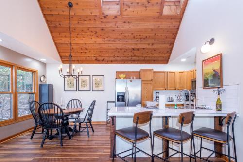 a kitchen and dining room with a table and chairs at House on Honeysuckle in Pisgah Forest