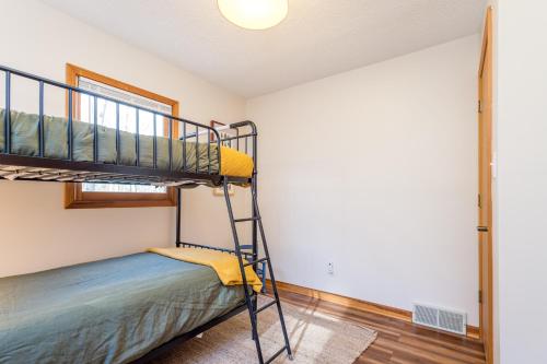 a room with a bunk bed and a ladder at House on Honeysuckle in Pisgah Forest