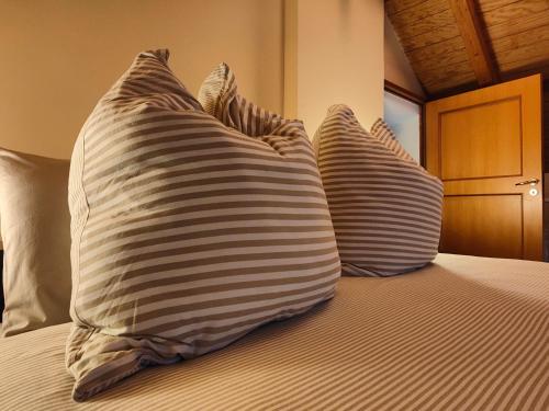 two pillows sitting on top of a bed at VILLA VICINUS - 120 mq - parking - garden in Vietri sul Mare