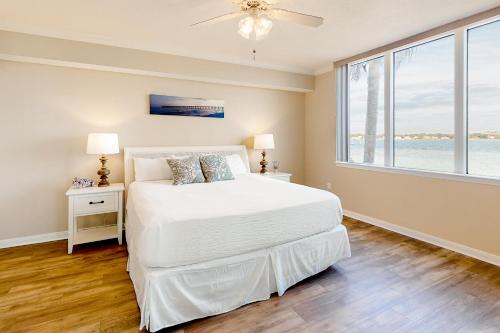 a bedroom with a bed and a large window at Destin West Resort - Bayside Osprey L2 in Fort Walton Beach