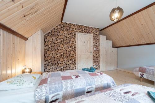 1 Schlafzimmer mit 2 Betten und einer Holzwand in der Unterkunft Osada Rybacka in Kopalino